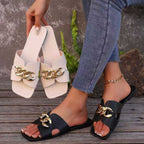 Chain embellished slide sandals in neutral tones from Plush Fashion Hub, featuring a comfortable slip-on design and decorative chain details.