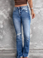 Distressed flare denim jeans by Plush Fashion Shop featuring ripped details and a high-waist fit, displayed on a model.