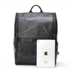 Black leather computer backpack with plush finish from Plush Fashion Hub, featuring multiple compartments and adjustable straps.