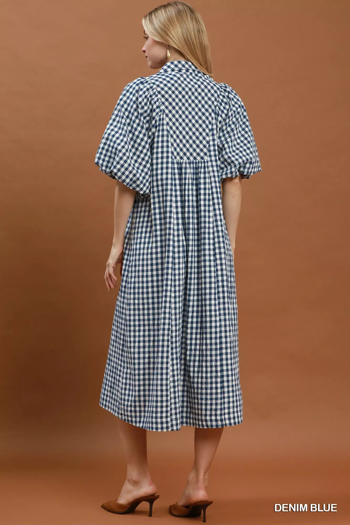 Umgee puff sleeve plaid midi dress with a fitted waist and ruffled hem, featuring a classic red and black checkered pattern.