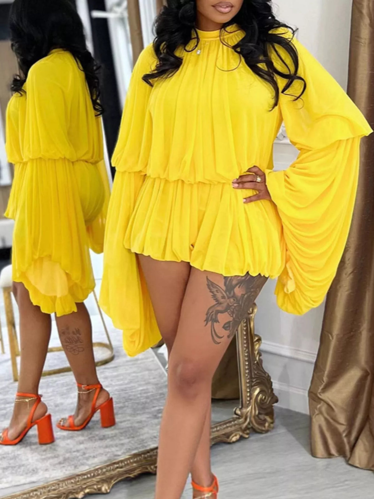 Elegant pleated bell sleeve romper by Trendsi, shown in a stylish, flowing design with ruffled bell sleeves and a fitted waist.