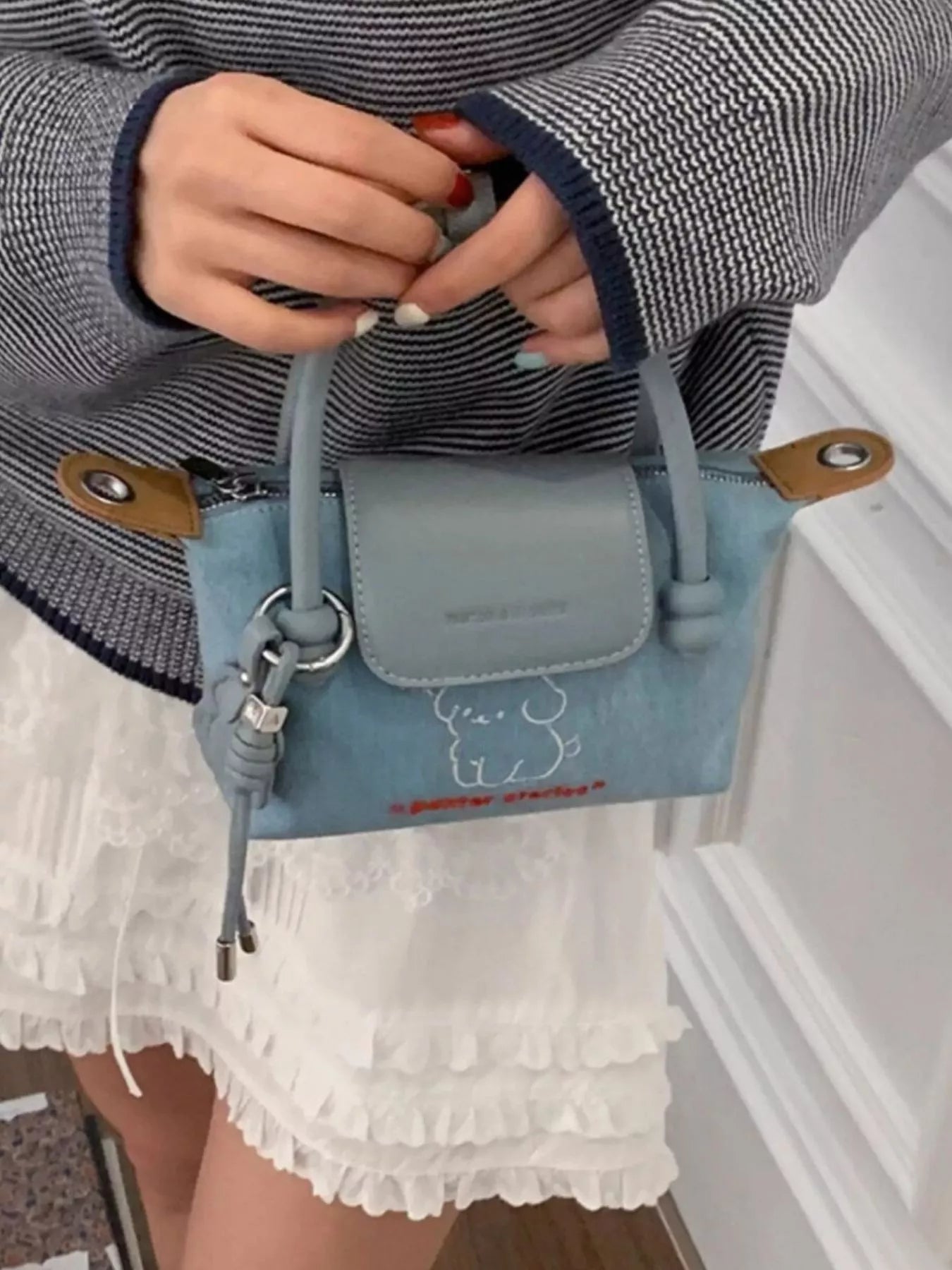 Embroidered denim handbag with puppy design, featuring plush fashion hub branding, stylish and casual accessory for everyday use.