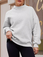 Women's oversized gray mock neck sweatshirt with dropped shoulders, casual fit, trendy tops by Trendsi displayed on a model.