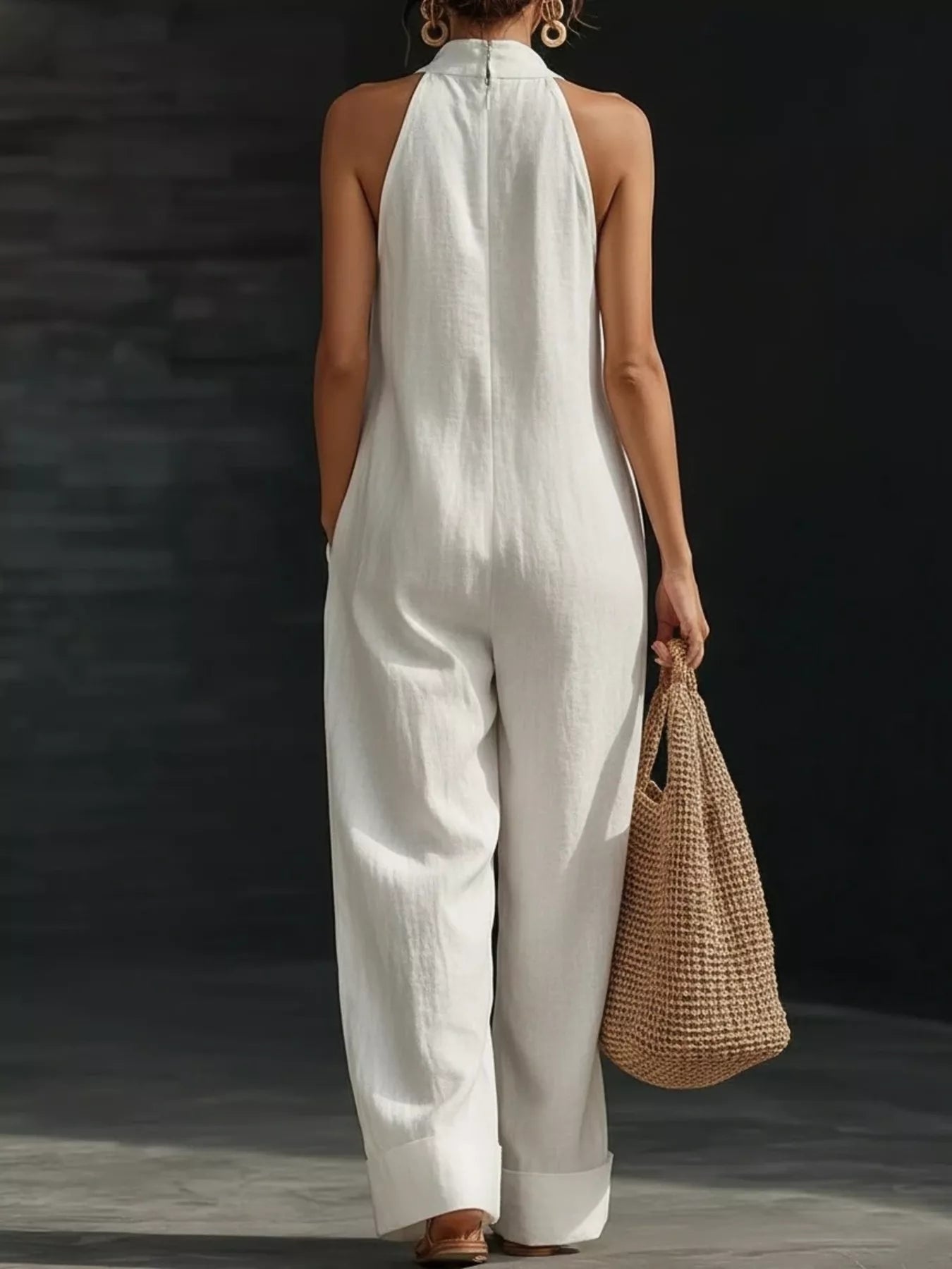 Halter neck wide-leg jumpsuit from Trendsi, featuring a stylish design with a fitted top and flowing wide-leg pants.