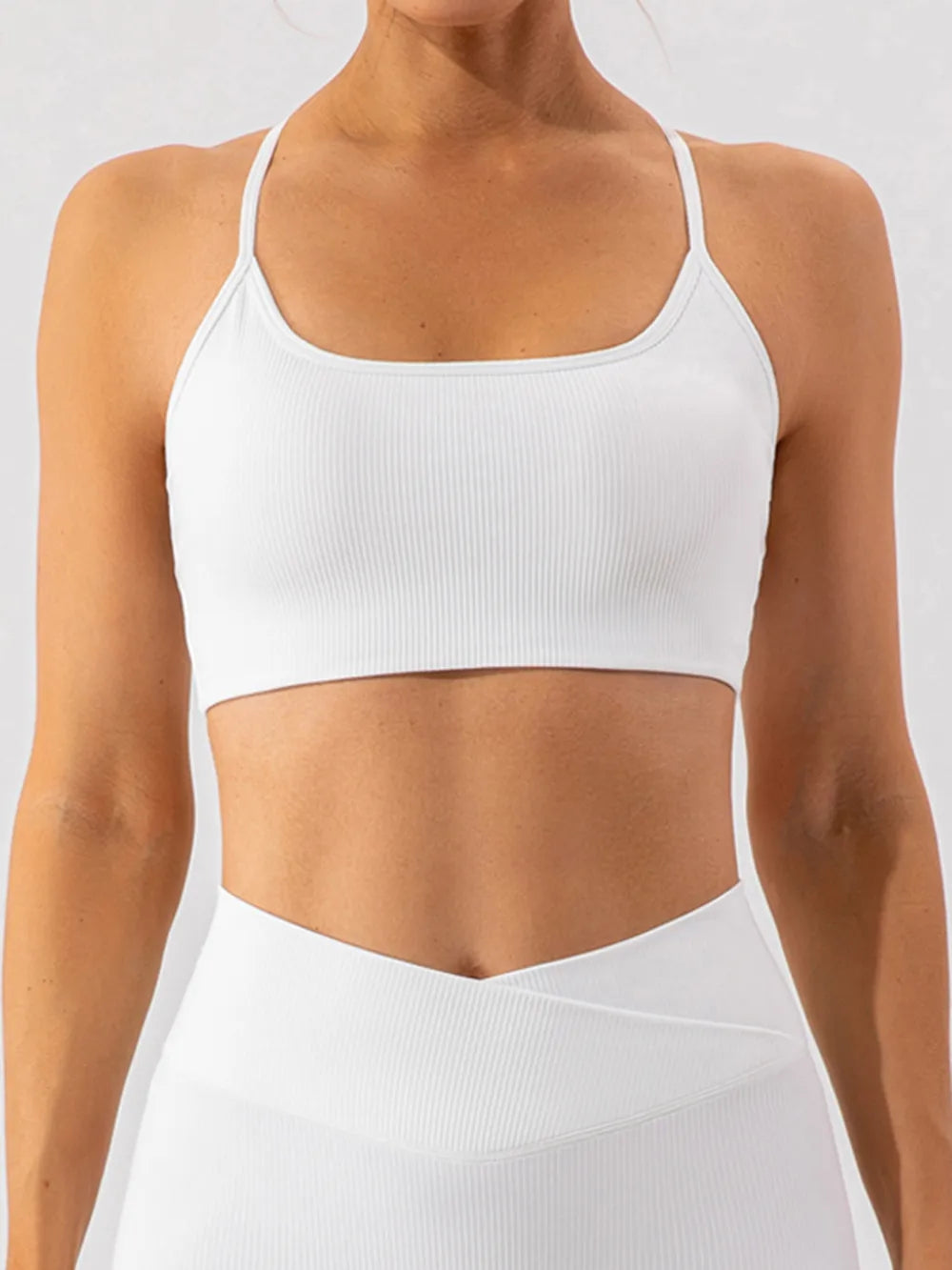 Trendsi spaghetti strap active bra in black, featuring lightweight, breathable fabric and adjustable straps for workout comfort.