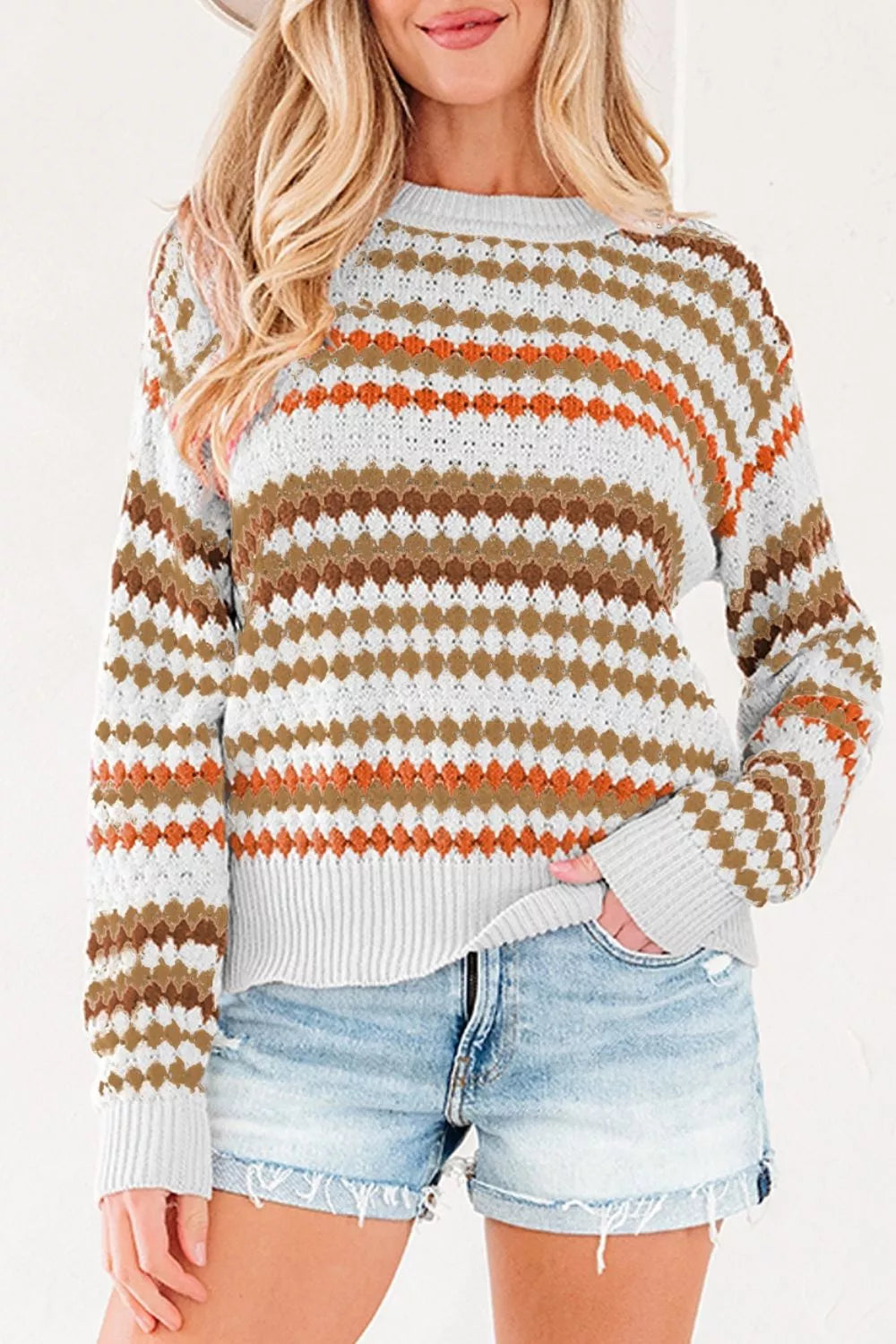 Women's striped geometric pattern sweater by Trendsi, featuring bold colorful stripes and cozy knit fabric.