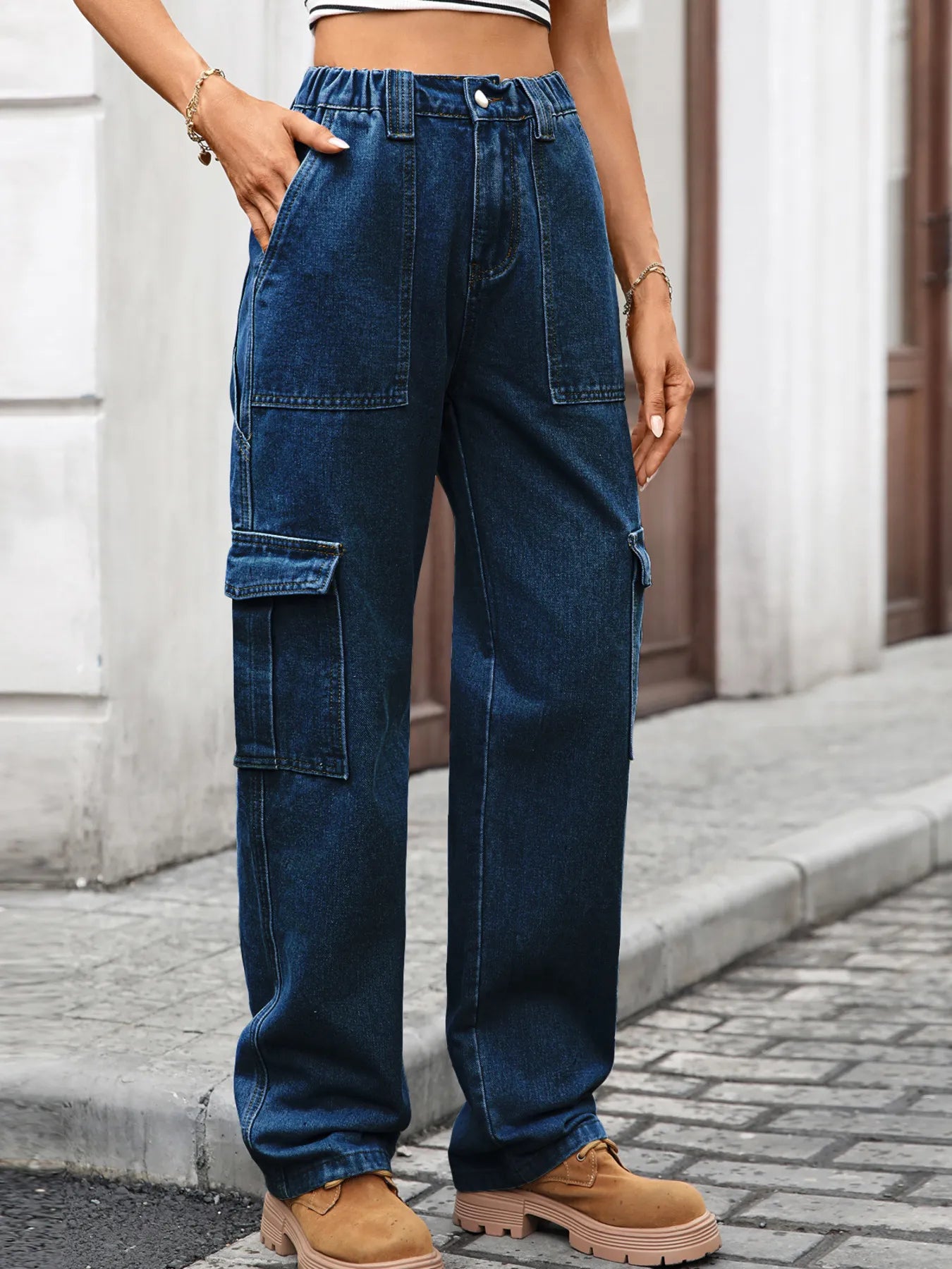 High-waisted cargo denim jeans from Plush Fashion Shop with multiple pockets and a relaxed fit, displayed on a white background.
