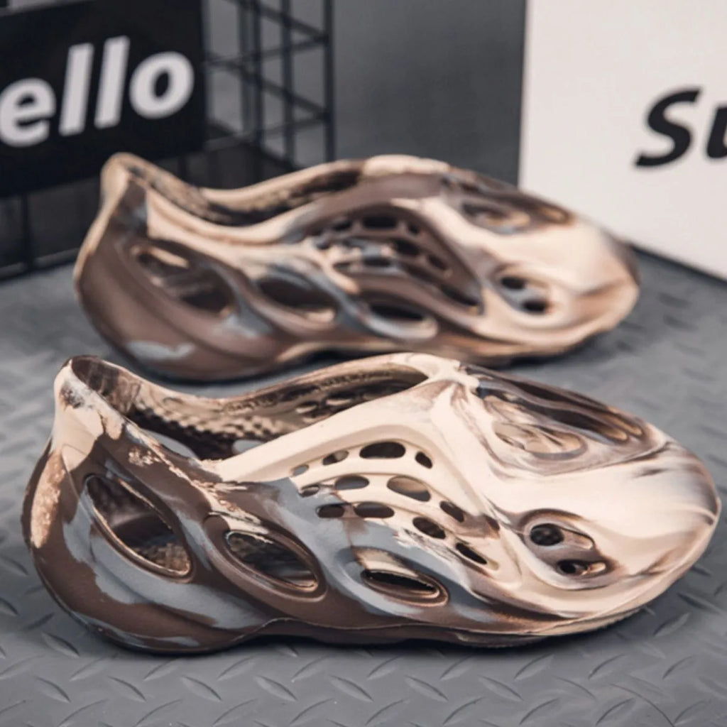 Trendsi hollow-out flat sandals with open toe design and minimalist style, featuring cut-out details on the footwear.