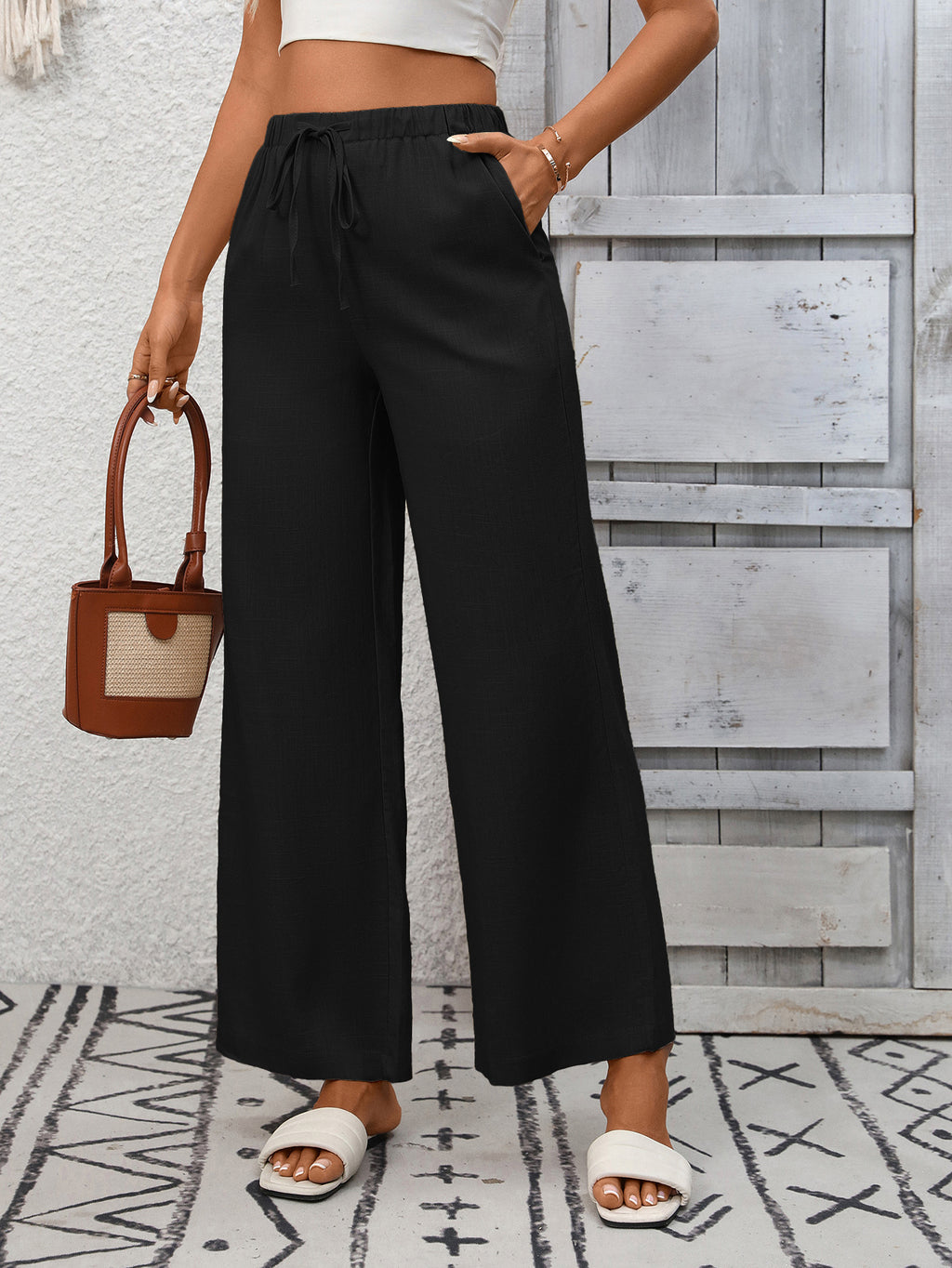 Women's high-waisted wide-leg drawstring pants in soft breathable viscose, featuring a relaxed fit and comfortable style.