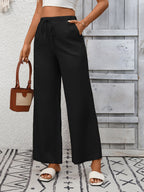 Women's high-waisted wide-leg drawstring pants in soft breathable viscose, featuring a relaxed fit and comfortable style.