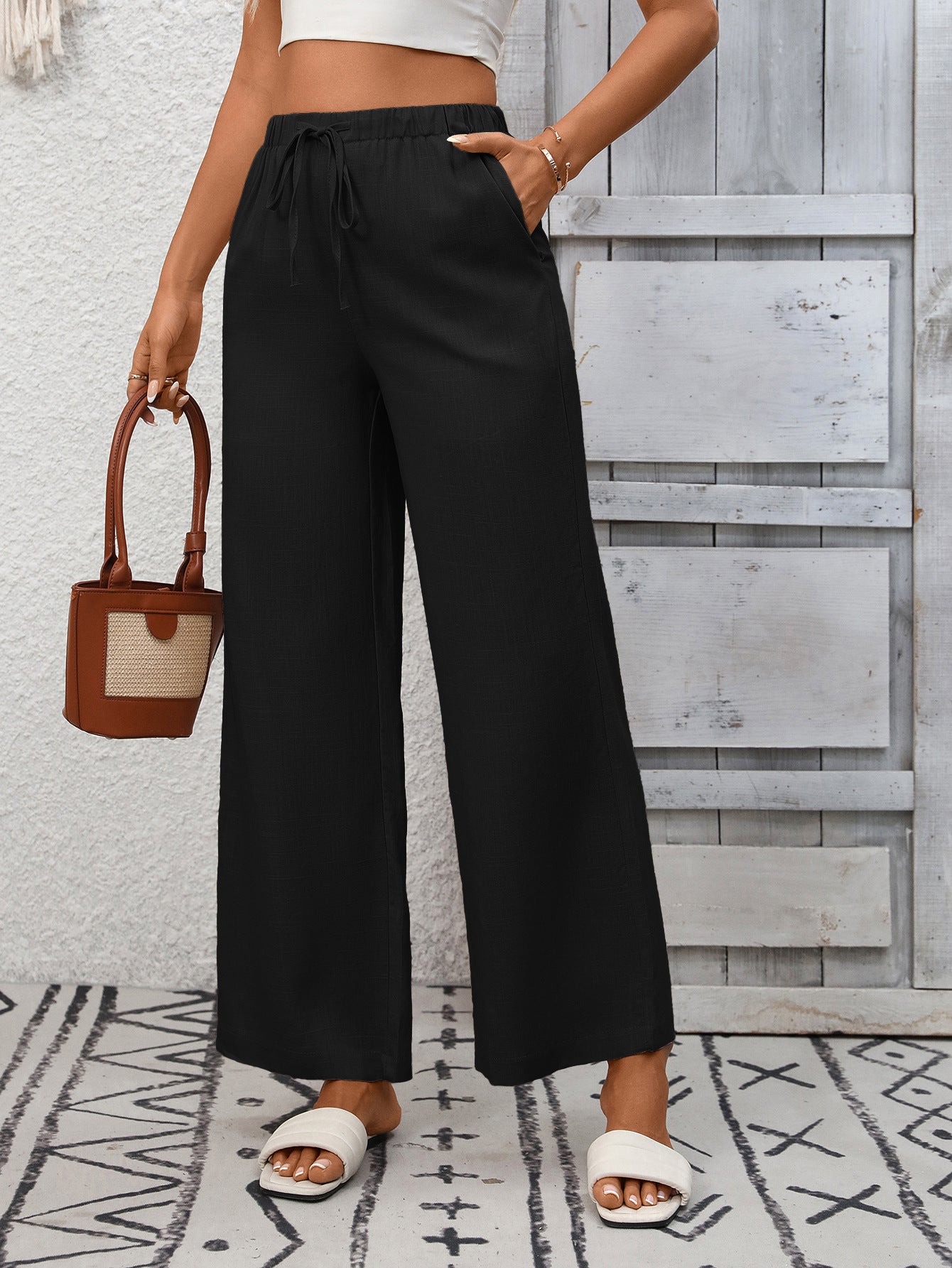 Women's high-waisted wide-leg drawstring pants in soft breathable viscose, featuring a relaxed fit and comfortable style.