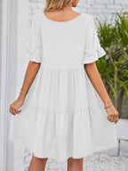 Lightweight rayon mini dress with ruffled sleeves, tiered design, and pockets, featuring a stylish and feminine look.
