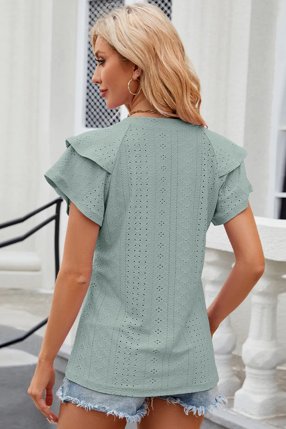 Eyelet notched flutter sleeve T-shirt from Trendsi, featuring lightweight fabric, flutter sleeves, and eyelet details.