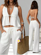 Women's chic halter neck cami and drawstring pants two-piece set from Trendsi, featuring stylish and comfortable matching outfit.