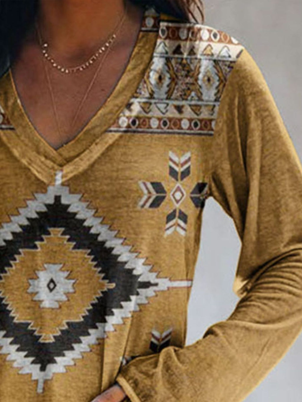 Plus size Trendsi geometric print V-neck long sleeve T-shirt with a casual fit, featuring bold geometric patterns and comfortable fabric