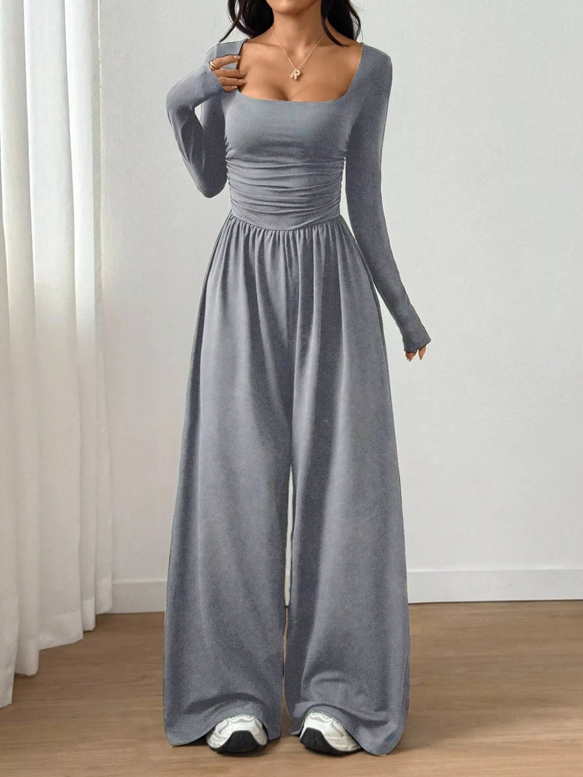 Ruched square neck wide-leg jumpsuit by Trendsi, featuring a stylish design with a fitted bodice and flowing wide-leg pants.