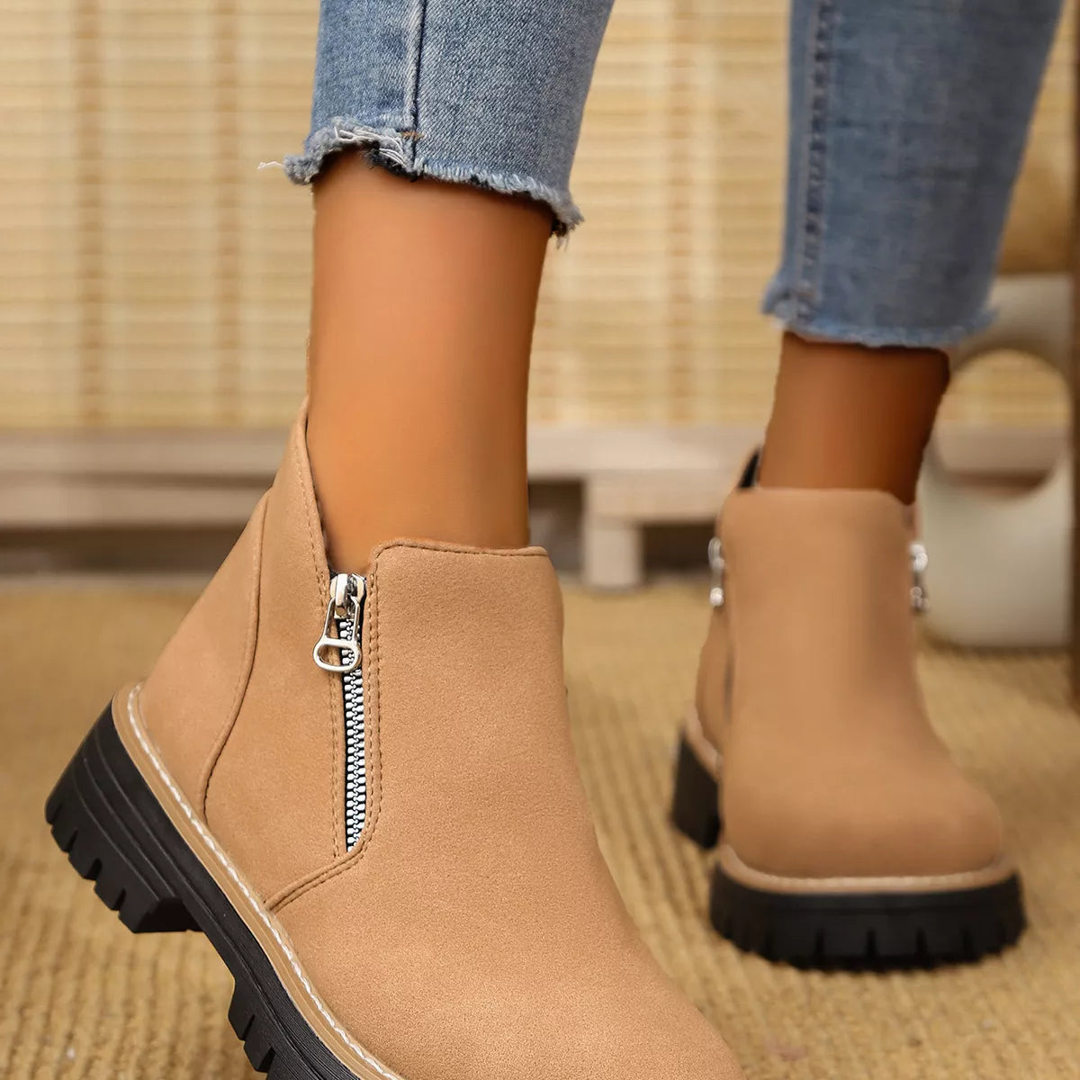 Black ankle boots with zipper accent from Trendsi, featuring a stylish design and sturdy sole for casual or dressy wear.