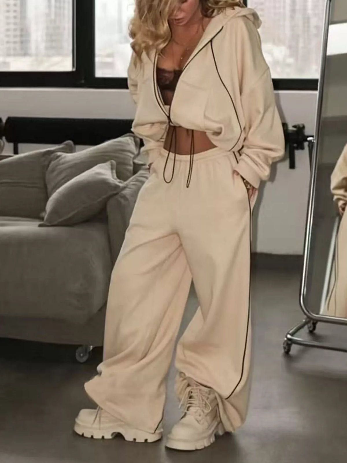 Trendsi cropped zip-up hoodie and wide-leg sweatpants lounge set displayed on a hanger, in soft neutral tones.