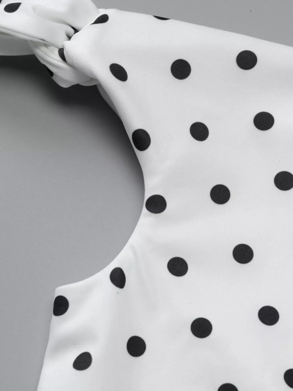 Polka dot sleeveless mini dress with bow accents by Shopimist, featuring a fitted silhouette and playful pattern.
