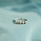 Sterling silver ring with inlaid zircon stones, crafted from 925 silver, featuring a detailed and elegant design.