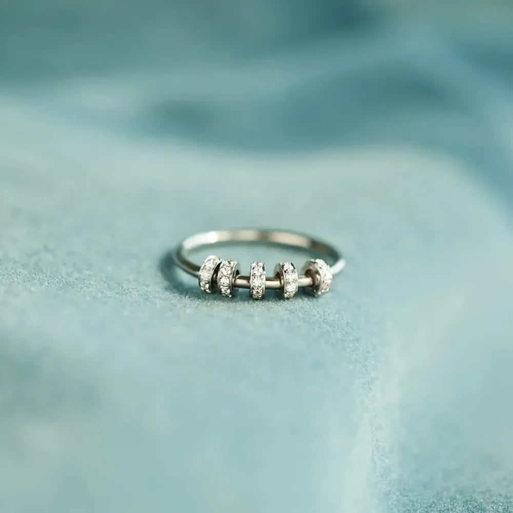 Sterling silver ring with inlaid zircon stones, crafted from 925 silver, featuring a detailed and elegant design.