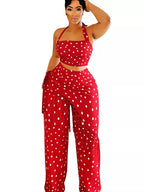 Polka dot halter neck cami and fringe trim pants set with rings, stylish trendy fashion by Trendsi, shown on a model.