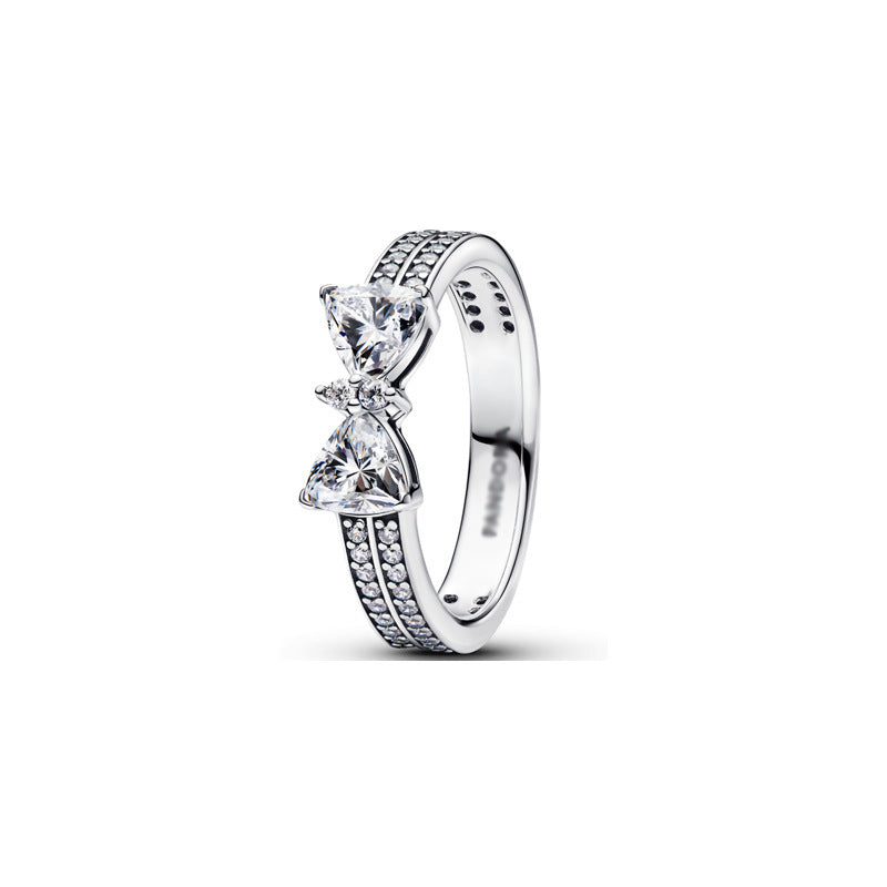 Silver metal double-band ring with a crystal bow and pavé stones.