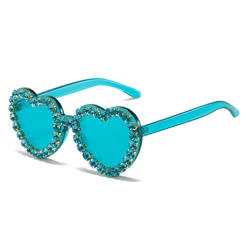 Peach heart-shaped rhinestone sunglasses with Y2K style, featuring vibrant frame and decorative rhinestones, by Plush Fashion Hub.