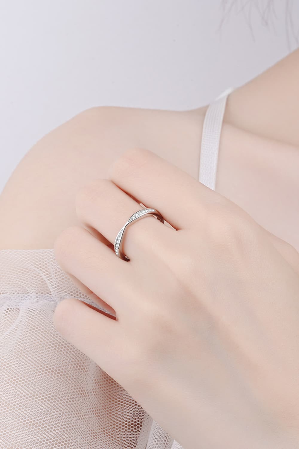 Rhodium-plated Moissanite ring with sparkling gemstone and sleek band, showcasing elegant jewelry design.