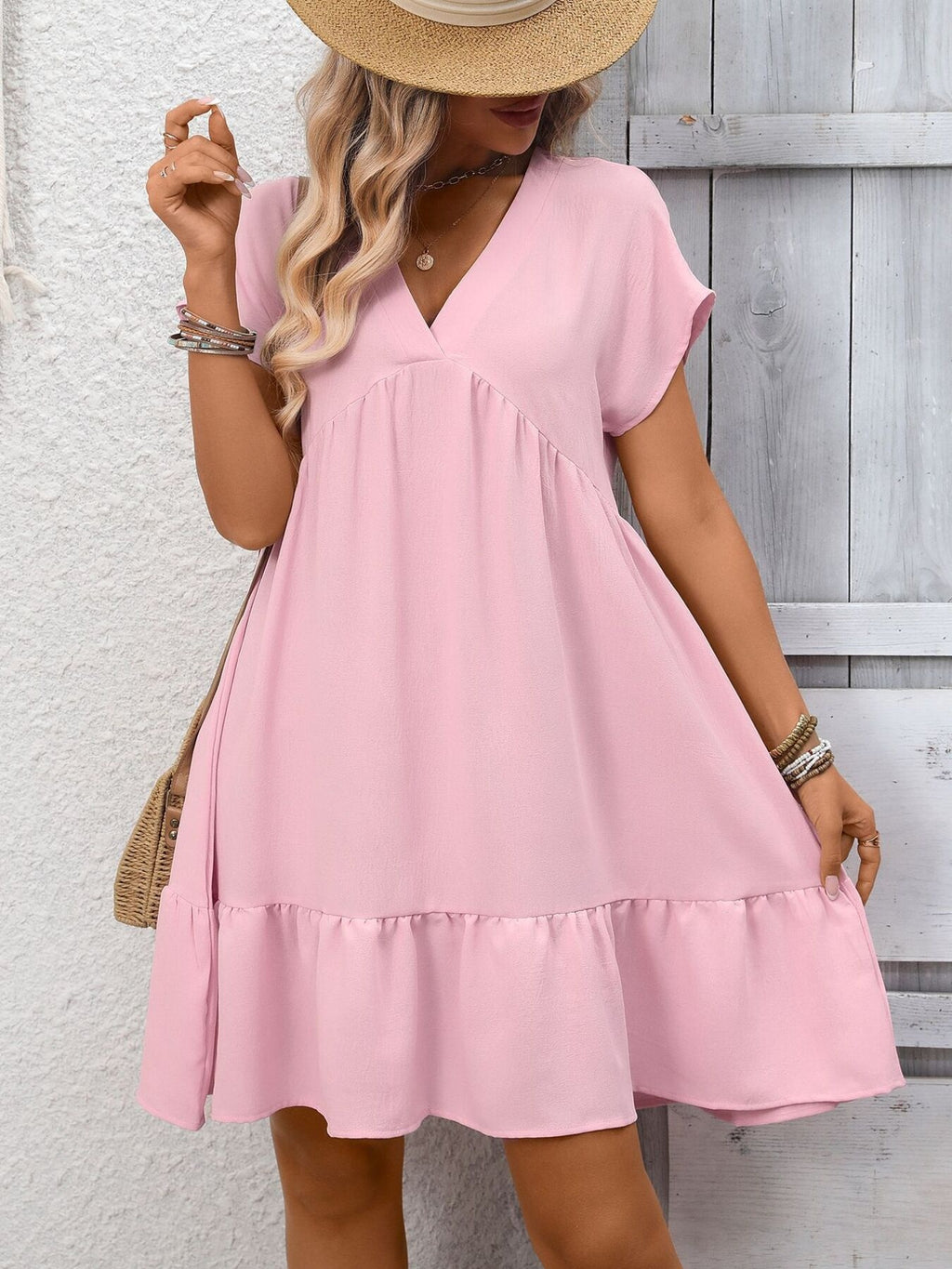 Women's casual V-neck mini dress with ruffle hem and ruched detailing by Trendsi, featuring a stylish and comfortable design.