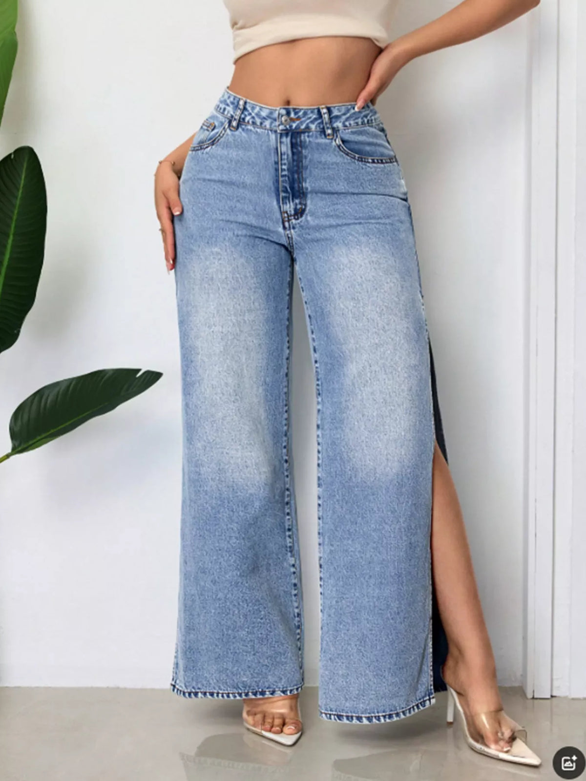 High-waisted wide-leg denim jeans with side slits by Trendsi, featuring a classic blue wash and relaxed fit.