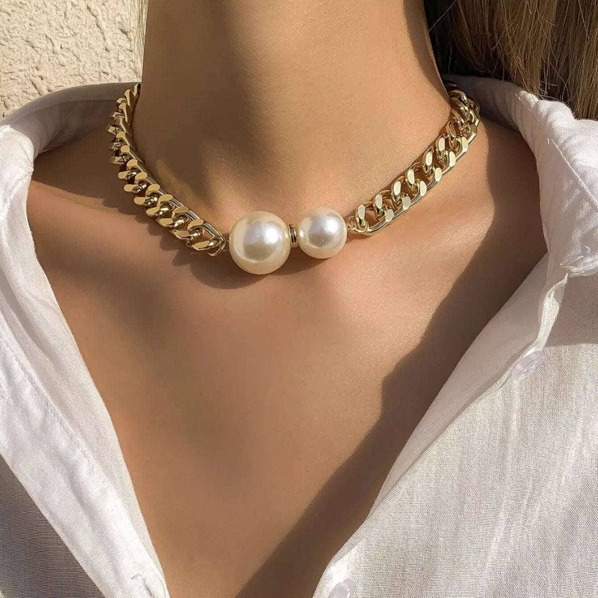 18K gold-plated pearl necklace featuring a delicate string of lustrous pearls on a plush fashion hub necklace.