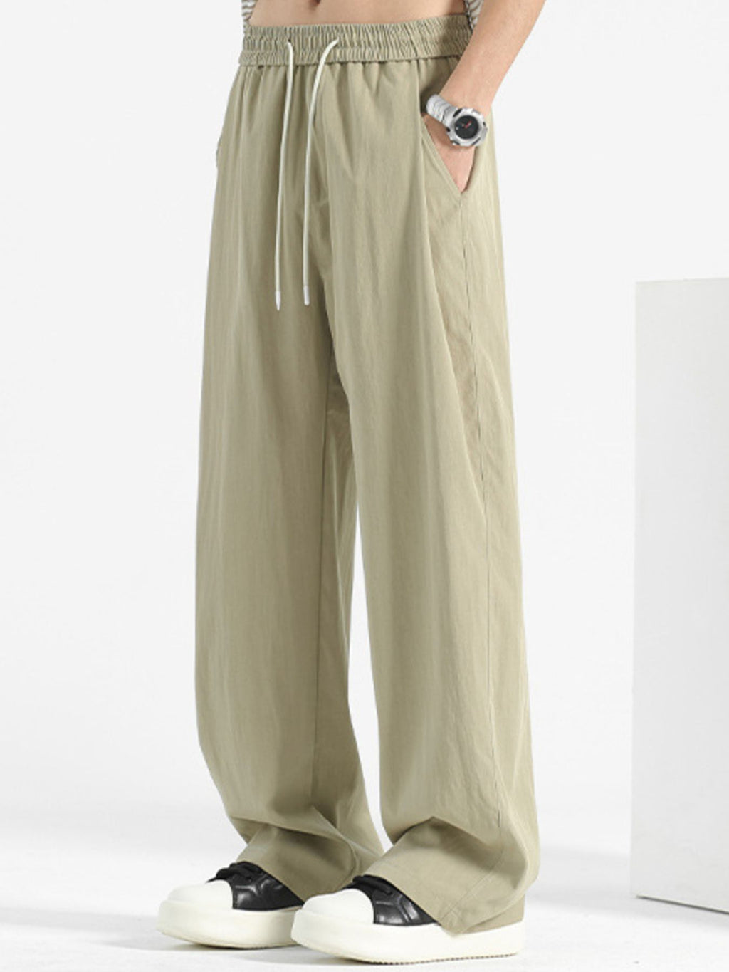 Men's loose fit casual pants with drawstring waist, relaxed fit, in neutral fabric, designed for comfort and everyday wear.
