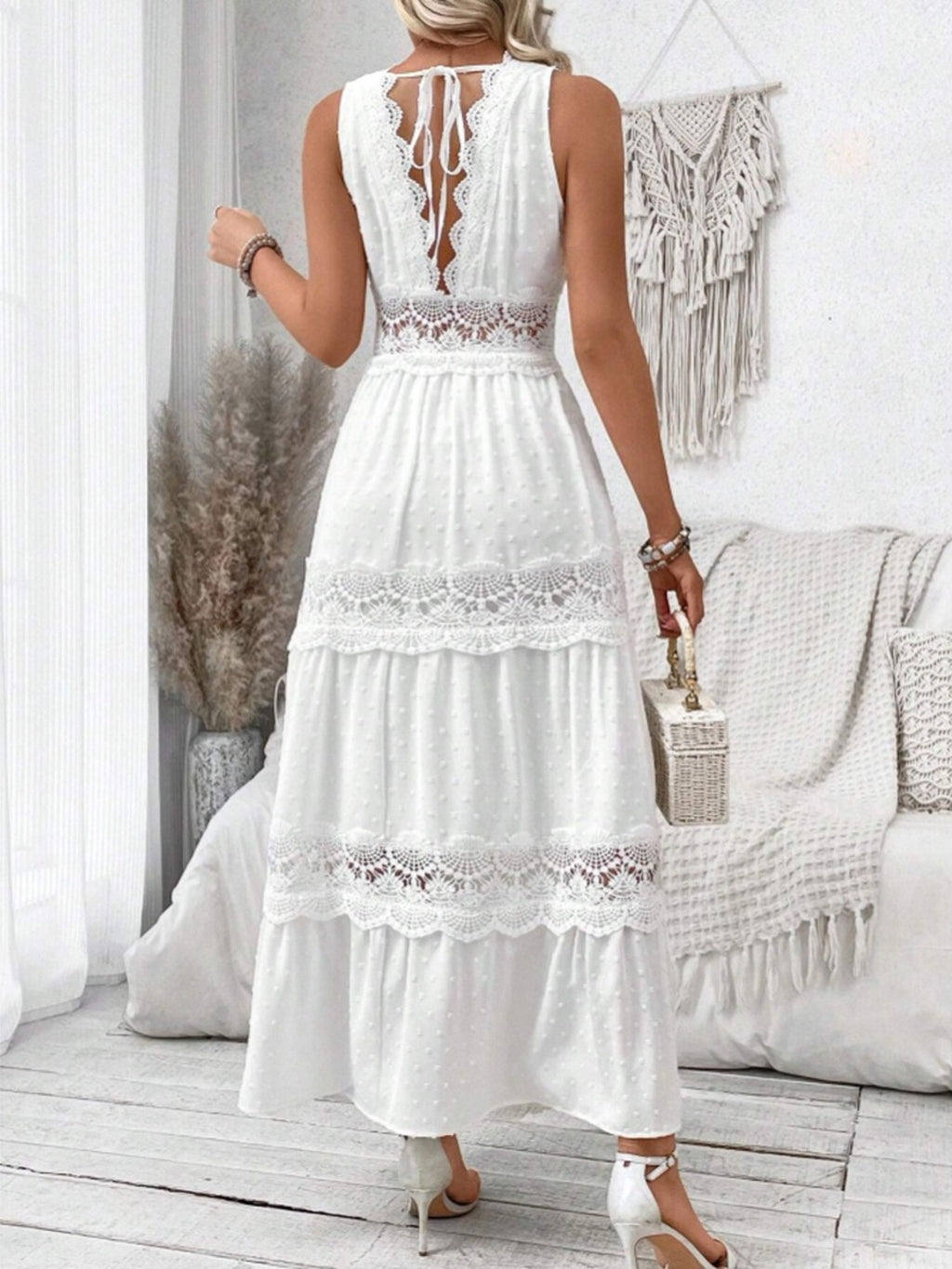 Sleeveless Swiss dot lace maxi dress with ruched tie detail, stylish and elegant for summer occasions.