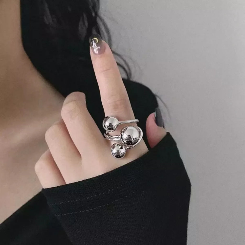 Shopimist multi-layered ball ring with stacked silver bands, featuring small ball accents and a sleek, modern design.
