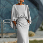 Women's silver backless pleated batwing sleeve maxi dress by FitiqueFit, elegant mermaid gown with flowing fabric and stylish design.