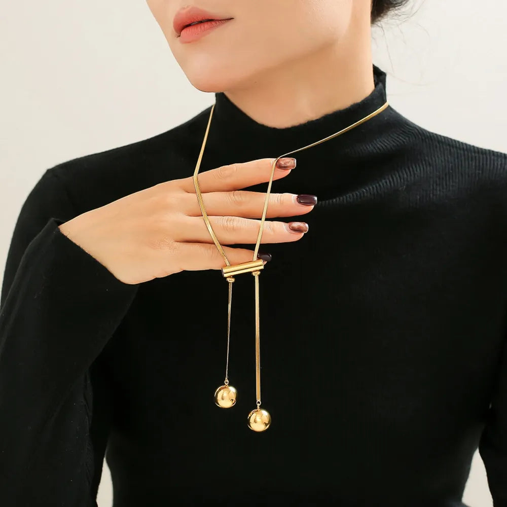 18K gold-plated titanium steel hollow bead necklace with round beads and smooth finish, stylish jewelry accessory.