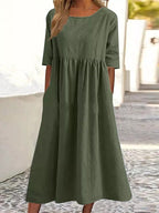 Plus size midi casual dress by FitiqueFit featuring a round neckline and front pockets, perfect for comfortable everyday wear.