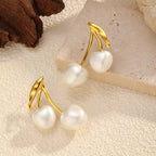 Pearl cherry drop earrings by Shopimist featuring dangling pearl and cherry-shaped charms on silver hooks.