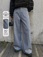 Shopimist striped wide-leg jeans with a high waist, featuring bold vertical black and white stripes and relaxed fit.