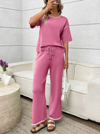 Women's casual two-piece lounge set with round neck top and drawstring pants, trendy and comfortable for relaxed wear.
