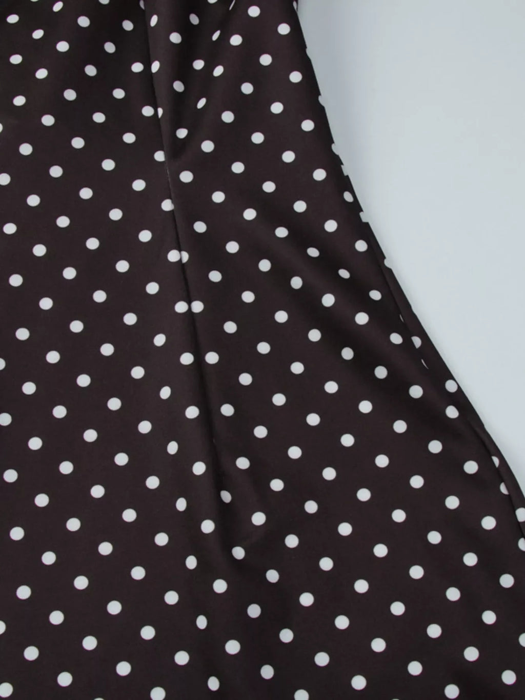 Polka dot cut-out front mini dress by Shopimist featuring a playful pattern and stylish design on a model.