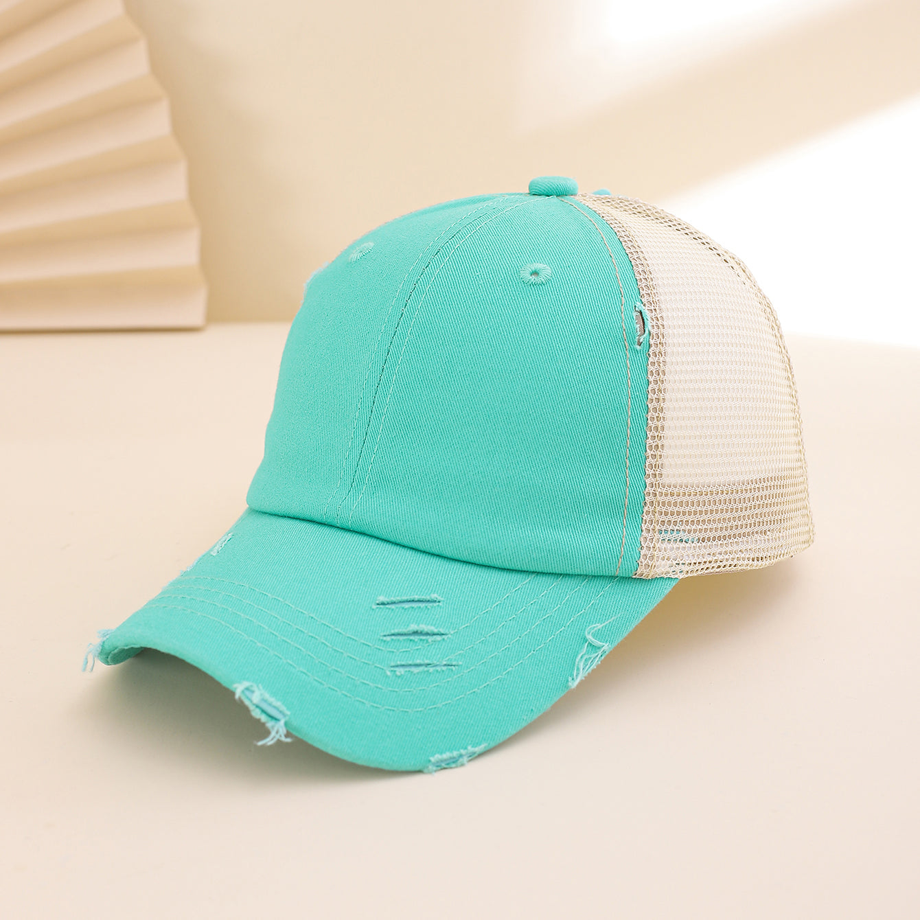 Distressed washed mesh baseball cap with frayed edges, unisex design, suitable for outdoor and daily wear, by Plush Fashion Hub.