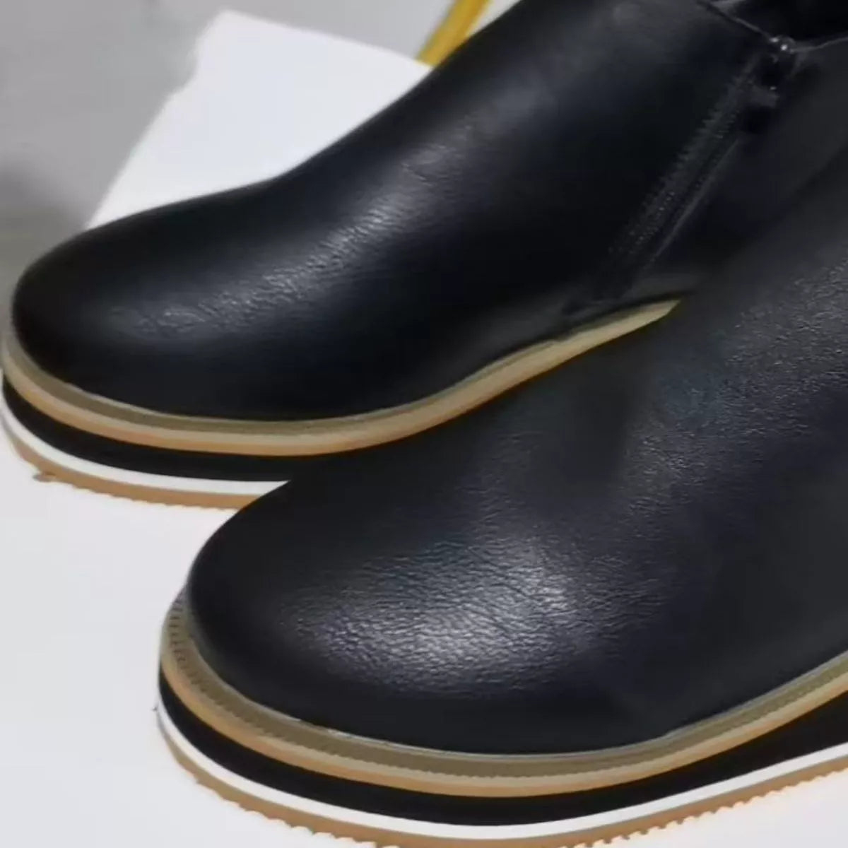 Women's ankle wedge boots with zipper detail, trendy trendy style, black leather, and chunky heel, perfect for fall fashion.