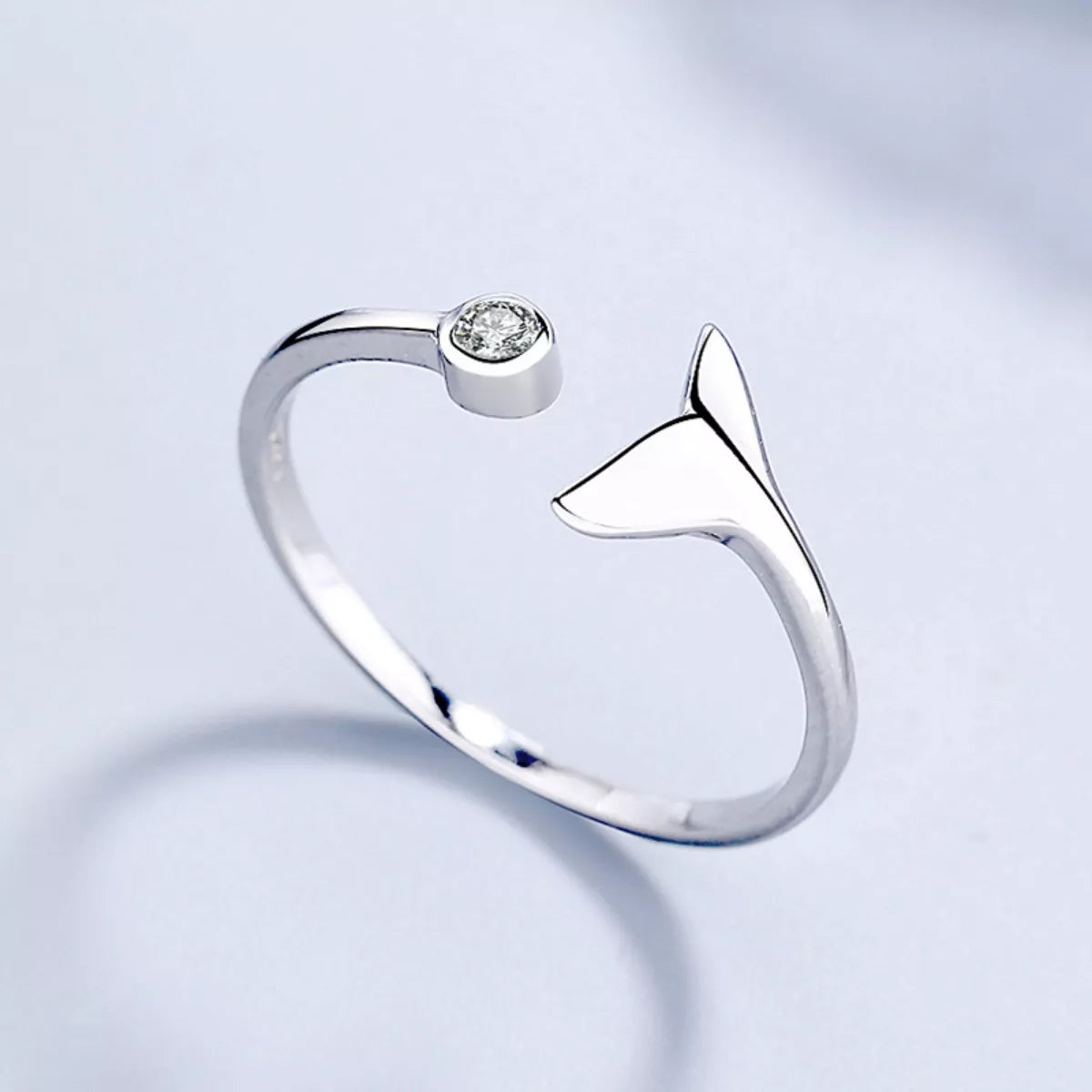 Sterling silver whale tail ring from Shopimist, featuring a detailed whale tail design on a sleek band.