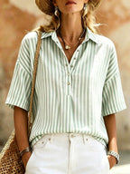 Women's striped short-sleeve shirt with turn-down collar from Plush Fashion Hub, featuring a casual, stylish design.