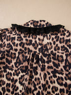 Leopard print short sleeve blouse with lace trim and button front from Plush Fashion Hub, stylish women's top with bold pattern.