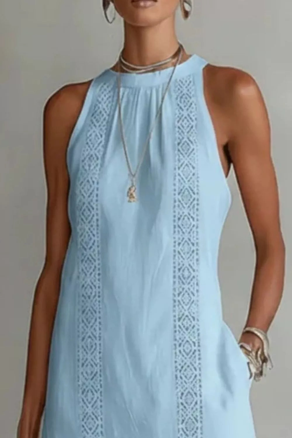 Women's sleeveless maxi dress with side slit and pockets by Plush Fashion Hub, flowing fabric and stylish design.