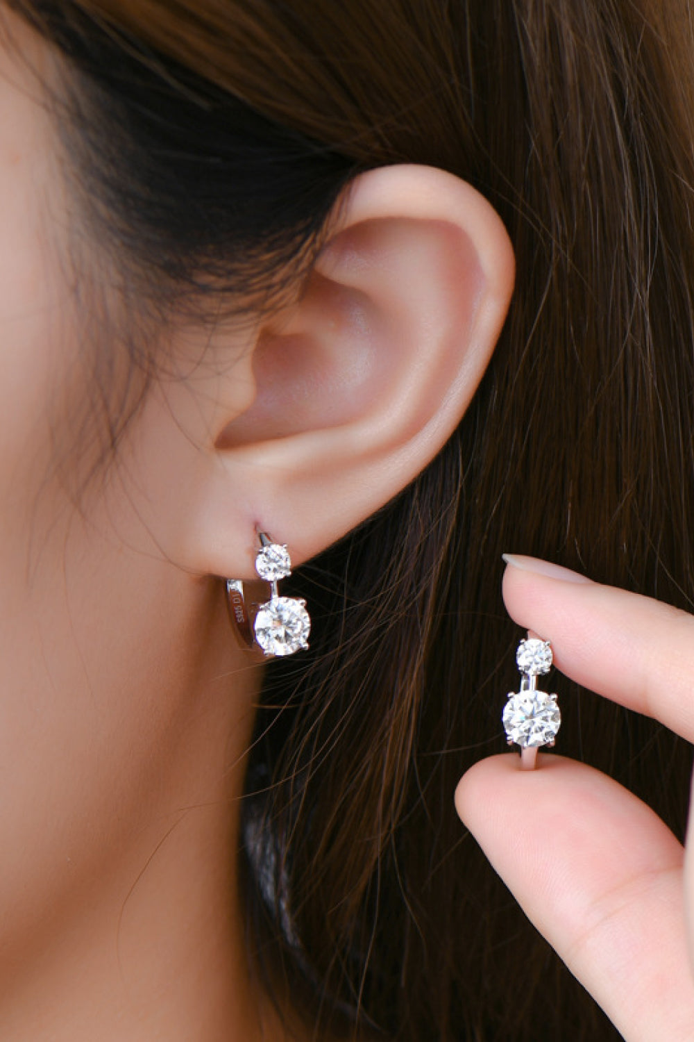 Sterling silver earrings with 1.3 carat moissanite gemstones, featuring elegant, sparkling stud design.
