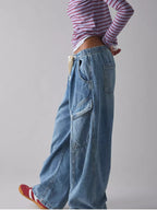 Women's relaxed fit cargo denim jeans with drawstring waist, utility style, by Trendsi, shown in a casual, full-length shot.